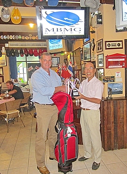 Simon Philbrook, left, presents the ‘MBMG Golfer of the Year’ trophy and prize to Mashi Kaneta.