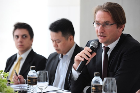 Raimon Land CEO Hubert Viriot, right, announces details of the company’s financial performance at a press conference held August 15 in Bangkok.