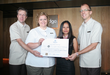 The latest winner of the ‘Dine ‘n’ Fly with Hilton Pattaya’ campaign was Benjaporn Hunt (2nd right), who received return airfares for two and two nights’ accommodation at the Hilton Kuala Lumpur, Malaysia. The Dine & Fly contest, which runs through Oct. 16, rewards Hilton customers who spend at least 3,000 baht in the Pattaya Hilton’s restaurants and spa. Grand prizes include trips to Koh Samui, Malaysia and Paris. (l-r) Michel Scheffers, Director of Operations, Hilton Pattaya, Peta Ruiter, Director of Business Development, Hilton Pattaya, Benjaporn Hunt and Harald Feurstein, GM Hilton Pattaya.