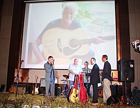 Jimmy Page “looks down from above” as Ronny Gorrie collects his great auction prize, a Jimmy Page signed guitar.  The legendary guitarist from Led Zeppelin donated his acoustic guitar inscribed with best wishes to Jesters Care for Kids, and included a beautiful case to protect it.  After a year-long wait from last year’s gala party night, the great success of this year’s event proved well worth the wait. 