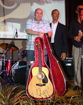 Ronny Gorrie held his nerve and with a final bid of B420,000 took home the Jimmy Page signed guitar inscribed with best wishes to Jesters Care for Kids.