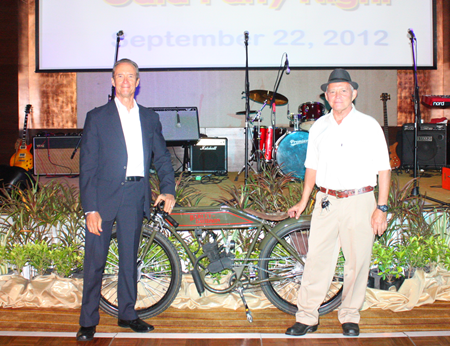 Woody and Bill proudly show off the vintage Harley up for grabs in the auction.