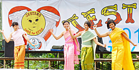 Girls from Ban Jing Jai Orphanage perform a traditional Thai dance after the rain stopped and the sun came out at the fair last year.  