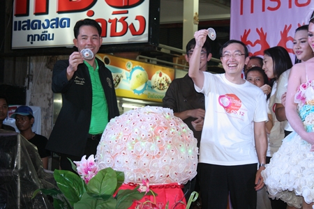 Mayor Itthiphol Kunplome (left) and UN Population Fund representative Dr. Taweepsap Siraprapassiri (right) hold up female condoms during Pattaya’s participation in the 1st ever Global Female Condom Day.