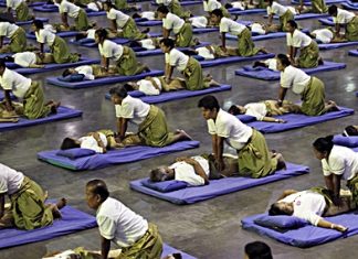 Thai masseuses perform mass massaging at a sports arena on the outskirts of Bangkok, Thursday, Aug. 30. Thailand has long been known as the massage capital of the world. Now, it has a Guinness World Record to prove it when some 641 massage therapists mass-massaged 641 people simultaneously for 12 minutes to win the honor Thursday. The event was organized by the Health Ministry to promote the Southeast Asian nation’s massage and spa industry. (AP Photo/Apichart Weerawong)