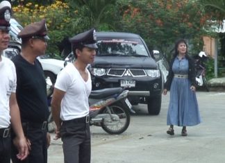 Sattahip police try to ignore the smartly dressed, and very loud unidentified woman as they go through their morning formation drills.
