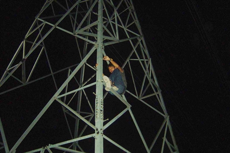 Wijit Saothong climbed an electricity tower and refused to come down.