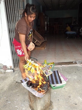 Naklua citizens burn silver and golden papers with the belief that this will light the way for spirits to make it to heaven.