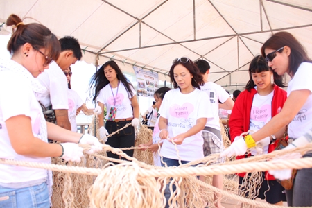Kamonwan Wipulakorn (center) helps make the artificial trees from ropes.