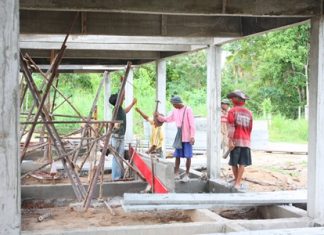 Constructions workers look busy as they try to complete the first phase of 10 houses by November.