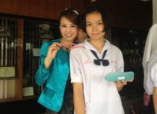 YWCA president, Praichit (Noy) Jetpai presents eyeglasses to a happy lady.