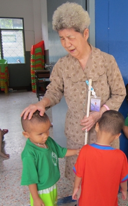 Aurora Sribuapun, principal of the school, with some of her younger students. 