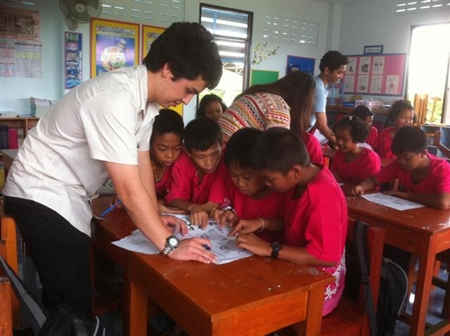 You can do it! An IB student helps youngsters speak English.