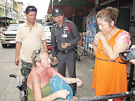 Anna Julun explains to police through a translator how she was robbed by two cowardly thieves. 