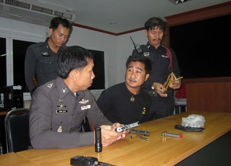 Throngkrit Thongnath (center) said he was only trying to break up a fight when he fired his weapon into the air near Bali Hai pier. 
