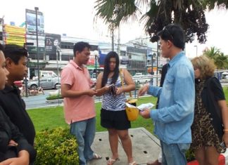 Anti-human trafficking police check the serial numbers of money an undercover agent used to sting Siriporn Poopan (center) for pimping her underage cousin.