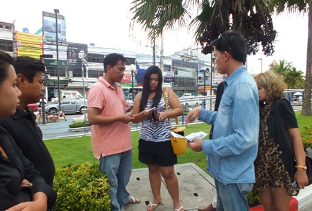Anti-human trafficking police check the serial numbers of money an undercover agent used to sting Siriporn Poopan (center) for pimping her underage cousin.