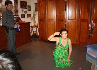 Suzette Lage shows police how the home intruders knocked her down and put a gun to her head.