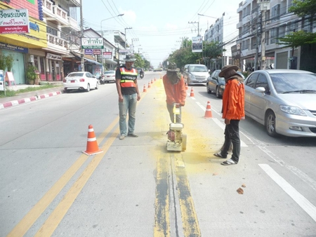 Road workers repaint lines at the 3rd Road intersection with Soi Phettrakul in North Pattaya. 