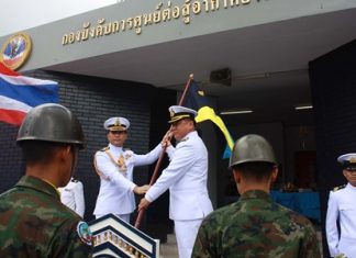 Outgoing commander, Capt. Buan Mattawanukul (left) hands over the leadership flag to Capt. Somprasong Wisoldilokpanth.