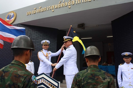 Outgoing commander, Capt. Buan Mattawanukul (left) hands over the leadership flag to Capt. Somprasong Wisoldilokpanth. 