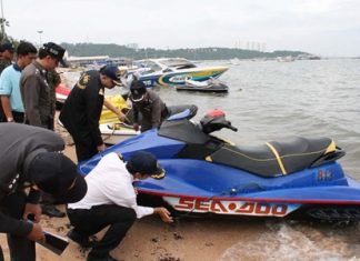 Officials inspect and take photos of jet skis along Pattaya Beach in an attempt to end the national embarrassment of jet ski scams.