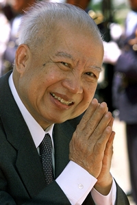 In this July 17, 2001 file photo, Cambodia’s King Norodom Sihanouk acknowledges the crowd while walking to greet North Korea’s national assembly leader Kim Yong Nam at Phnom Penh airport, in Cambodia. (AP Photo/Andy Eames, File)