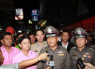 Reporters converge on police officials doing a walk through of Walking Street.