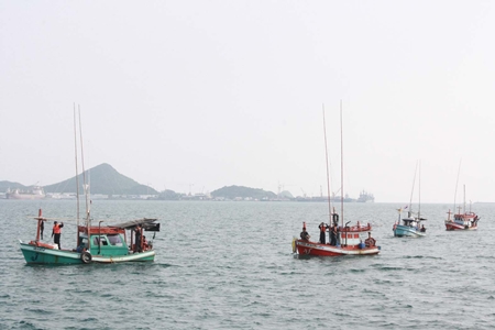 Navy officials bring in the boats illegally stocked with Cambodian fishermen. 
