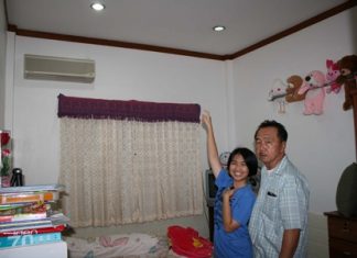 Happy she wasn’t killed, Raphatsorn points to the ceiling where the bullet entered through her roof. Her father doesn’t look so amused.