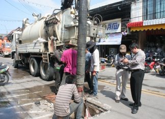 City officials inspect storm drains in Naklua as workers use heavy equipment to clear them of debris that might inhibit water flow during heavy rainfall.