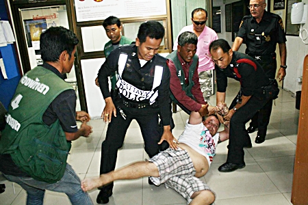 Police struggle to contain the drunken Belgian. 