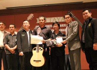 Natdanai Phuaphanprasong (center) receives his prize guitar after winning the 2012 Pattaya Guitar Festival.