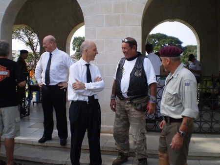 The British Ambassador Mark Kent greets some of the bikers.
