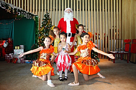 Santa surrounded by little dancers.