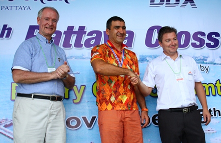 Ronny Heltne (right) congratulates Mark Lunev (middle), winner of the 1.2 km male category, as President Dieter Reigber applauds.