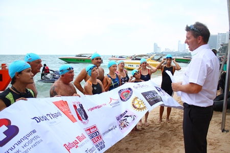 Ronny Heltne (right) explains the rules to swimmers of the 1.2 km race from in front of the Hard Rock Hotel.