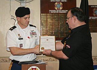 Commander Eric Larsen presents Major Daniel Robinson with a certificate of appreciation.