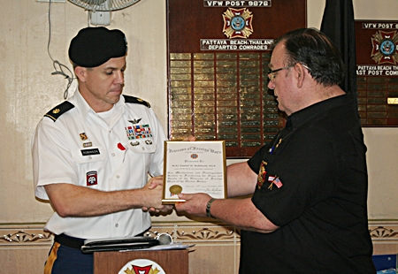 Commander Eric Larsen presents Major Daniel Robinson with a certificate of appreciation.