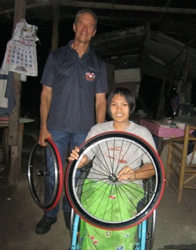 Jaruwan quickly settled into her ‘new’ wheelchair. Woody and Jaruwan are holding the set of spare tires for her wheelchair.