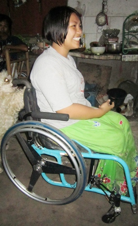 Even in the relative dark of night, that great smile of Jaruwan’s lights up the room in her refurbished wheelchair.