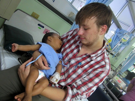 A volunteer with a very young baby.