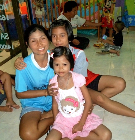 A volunteer with 2 of the older children.