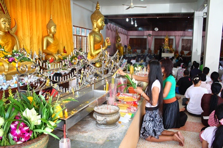 Buddhists visit local temples for merit-making and worshipping on Auk Pansaa.