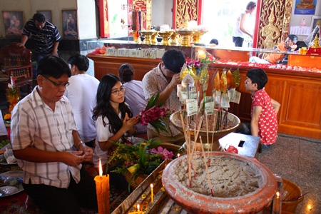 Buddhists worship Lord Buddha with flowers, incense and candles asking for blessing and for prosperity.