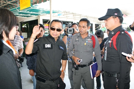 Police, Department of Special Investigations and Energy Ministry officials raid the Tianchai Petrochemical station on Sukhumvit Road.