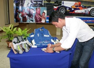 Tor Graves signs the jumpsuit, gloves and shoes he used in this year’s FIA World Endurance Championships.