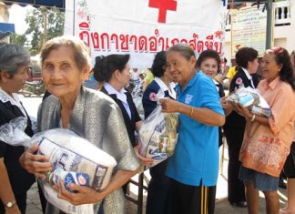 Happy residents pick up aid bags distributed through the Sattahip ‘Smile Mobile’ service program.