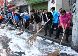 City officials grab brooms for a photo op to kick off this month’s Walking Street “Big Cleaning Day”.