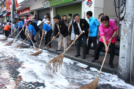 City officials grab brooms for a photo op to kick off this month’s Walking Street “Big Cleaning Day”.